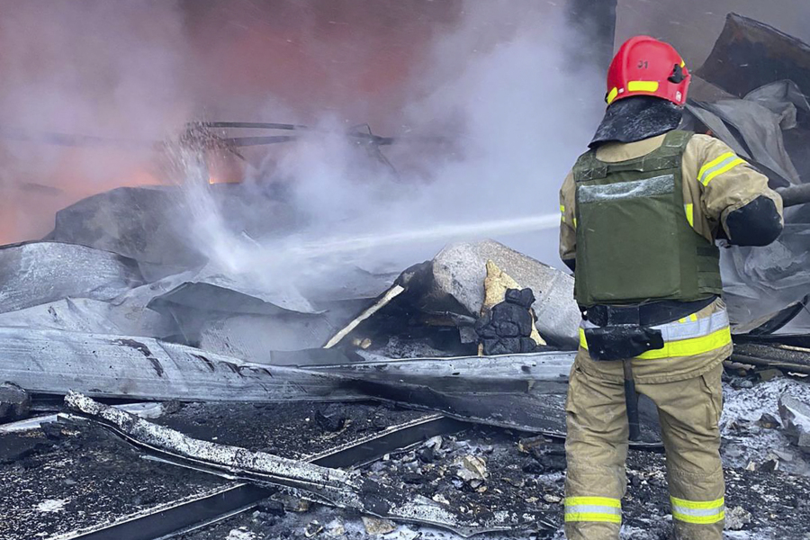 In this photo provided by the Ukrainian Emergency Service, a firefighter works to extinguish a fire after a Russian missile attack in Kryvyi Rih, Ukraine, Monday, Jan. 8, 2024.