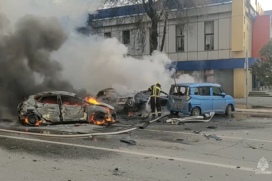 FILE - In this photo taken from video released by Russia Emergency Situations Ministry telegram channel on Dec. 30, 2023, firefighters extinguish burning cars after shelling in Belgorod, Russia. Belgorod has canceled its traditional Orthodox Epiphany festivities on Friday, Jan. 19, 2024 due to the threat of attacks as Kyiv&rsquo;s forces pursue a new strategy with the war approaching its two-year milestone.