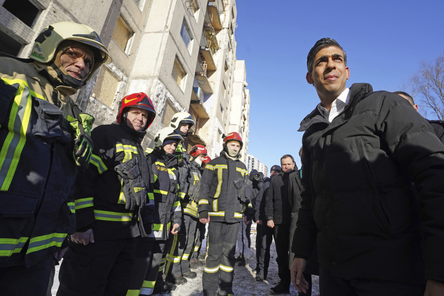 Prime Minister Rishi Sunak talks to firefighters in Kyiv, Ukraine, ahead of meeting with President Volodymyr Zelenskyy to announce a major new package of military aid to Ukraine, Friday, Jan. 12, 2024.