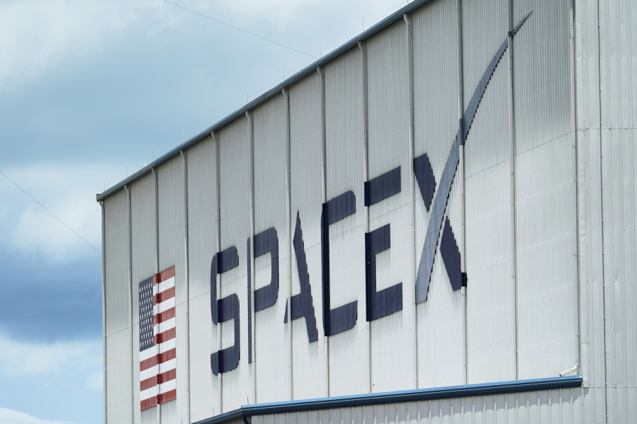 FILE - The SpaceX logo is displayed on a building, May 26, 2020, at the Kennedy Space Center in Cape Canaveral, Fla. On Wednesday, Jan. 3, 2024, a U.S. labor agency accused SpaceX of unlawfully firing employees who penned an open letter critical of CEO Elon Musk and creating an impression that worker activities were under surveillance by the rocket ship company. (AP Photo/David J.