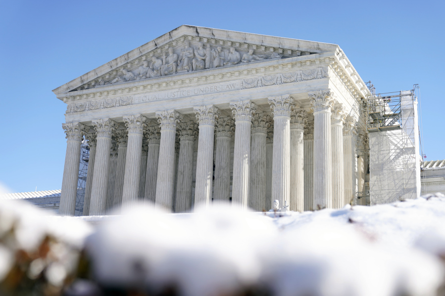 The U.S. Supreme Court is photographed through snow on Wednesday, Jan. 17, 2024, in Washington.