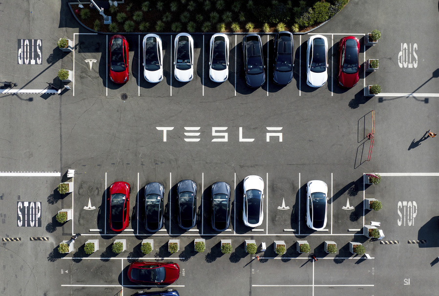 FILE - Tesla vehicles line a parking lot at the company&rsquo;s Fremont, Calif., factory, on Sept. 18, 2023.  Tesla&rsquo;s stock is faltering before the market open on Thursday as the electric vehicle, solar panel and battery maker cautioned on slower sales growth this year and posted weaker-than-expected quarterly earnings.