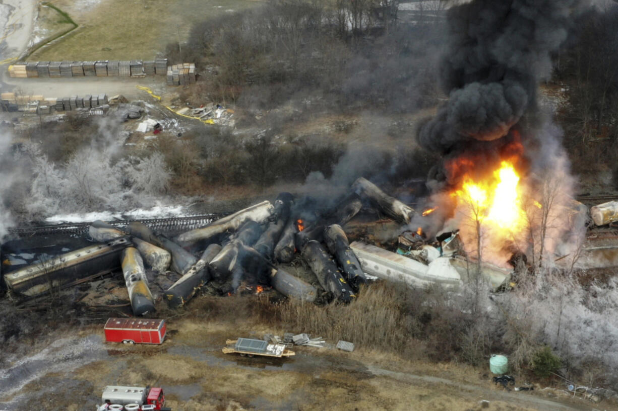 FILE - Portions of a Norfolk Southern freight train that derailed the night before burn in East Palestine, Ohio, Feb. 4, 2023. The White House says President Joe Biden will visit the eastern Ohio community that was devastated by a fiery train derailment in February 2023.  (AP Photo/Gene J.