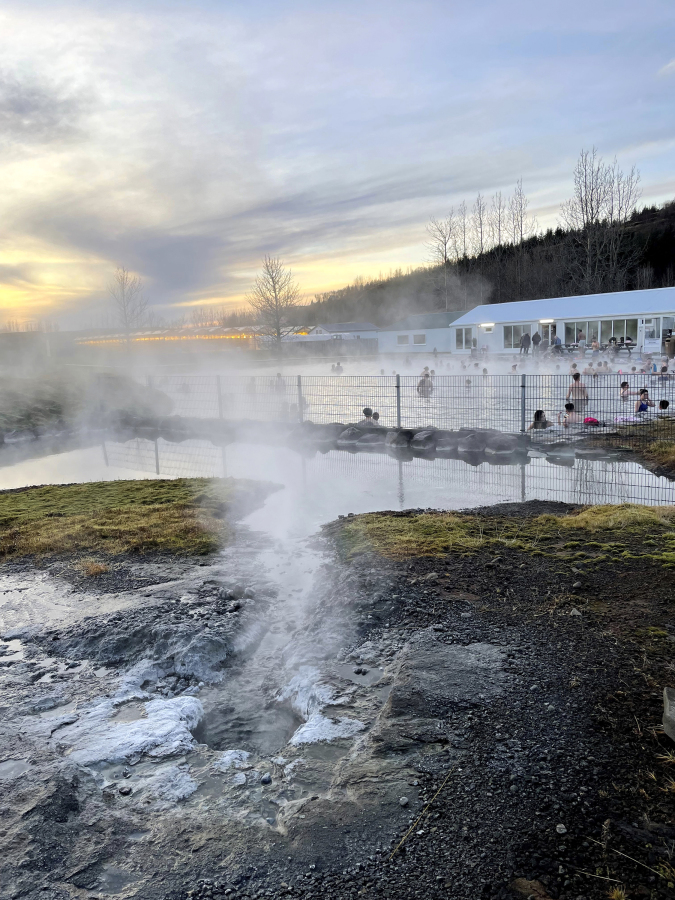 This Nov. 16, 2023 image provided by Beth Harpaz shows steam emanating from hot springs that supply geothermally heated water for the Secret Lagoon in the Hverah&oacute;lmi geothermal area off Iceland&rsquo;s Golden Circle route. The lagoon&rsquo;s outdoor pool is open year-round with water heated to just over 100 F (38-40 C).
