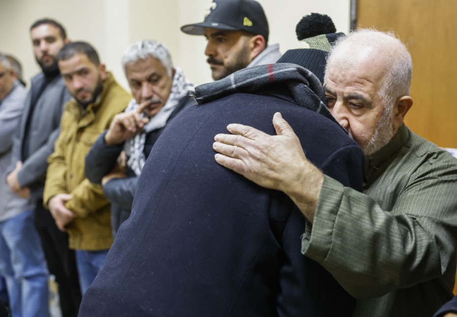 Abdelrehim Hamed hugs Mohammad Salem during the reception for his great-grandson Palestinian-American teenager Tawfiq Ajaq, 17, who was killed Friday by Israeli fire in the occupied West Bank, at Masjid Omar mosque in Harvey, La., Saturday, Jan. 20, 2024.
