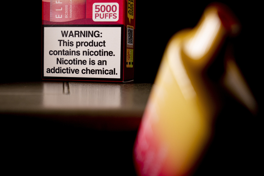 FILE - A health warning is seen on the packaging of a disposable vaping pod device in Washington on Monday, June 26, 2023. Sixty years ago, the U.S. surgeon general released a report that settled a longstanding public debate about the dangers of cigarettes and led to huge changes in smoking in America.