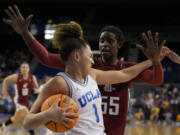 Washington State center Bella Murekatete, right, defends against UCLA guard Kiki Rice during the second half of an NCAA college basketball game, Sunday, Jan. 28, 2024, in Los Angeles.