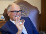 Washington Gov. Jay Inslee laughs after surprising staff by blowing his father&#039;s coaching whistle while running through his State of the State address in his office on the second day of the legislative session at the Washington state Capitol, Tuesday, Jan. 9, 2024, in Olympia, Wash.