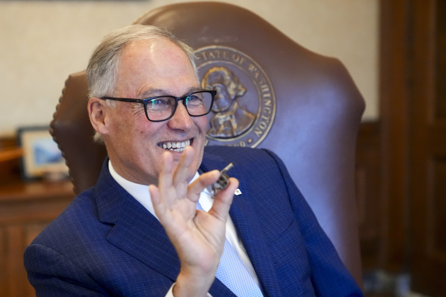Washington Gov. Jay Inslee laughs after surprising staff by blowing his father&#039;s coaching whistle while running through his State of the State address in his office on the second day of the legislative session at the Washington state Capitol, Tuesday, Jan. 9, 2024, in Olympia, Wash.