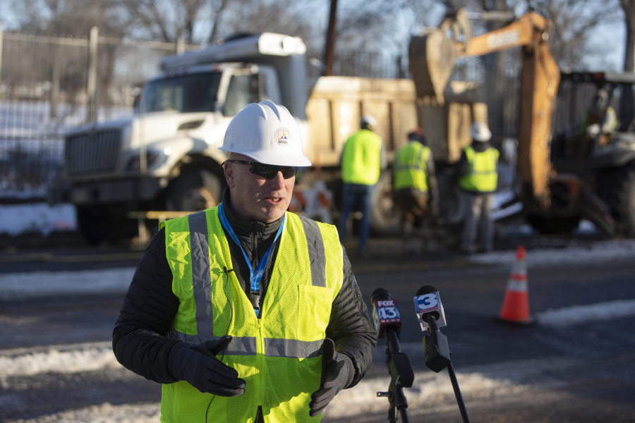 Doug McGowen, president and CEO of Memphis Light, Gas and Water, speaks to the media as a MLGW crew fixes a water main break behind him in Memphis, Tenn., on Saturday, Jan. 20, 2024. McGowen noted that as the temperature warms up and more ice begins to melt Sunday, more leaks are likely to be discovered.