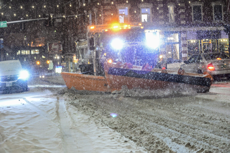 A plow from the Brattleboro, Vt., Public Works Department removes snow on Main Street on Tuesday, Jan. 9, 2024.