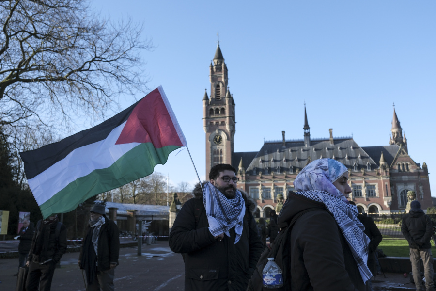 Protesters and media gather outside the Peace Palace, which houses the International Court of Justice, or World Court, on Friday in The Hague, Netherlands.