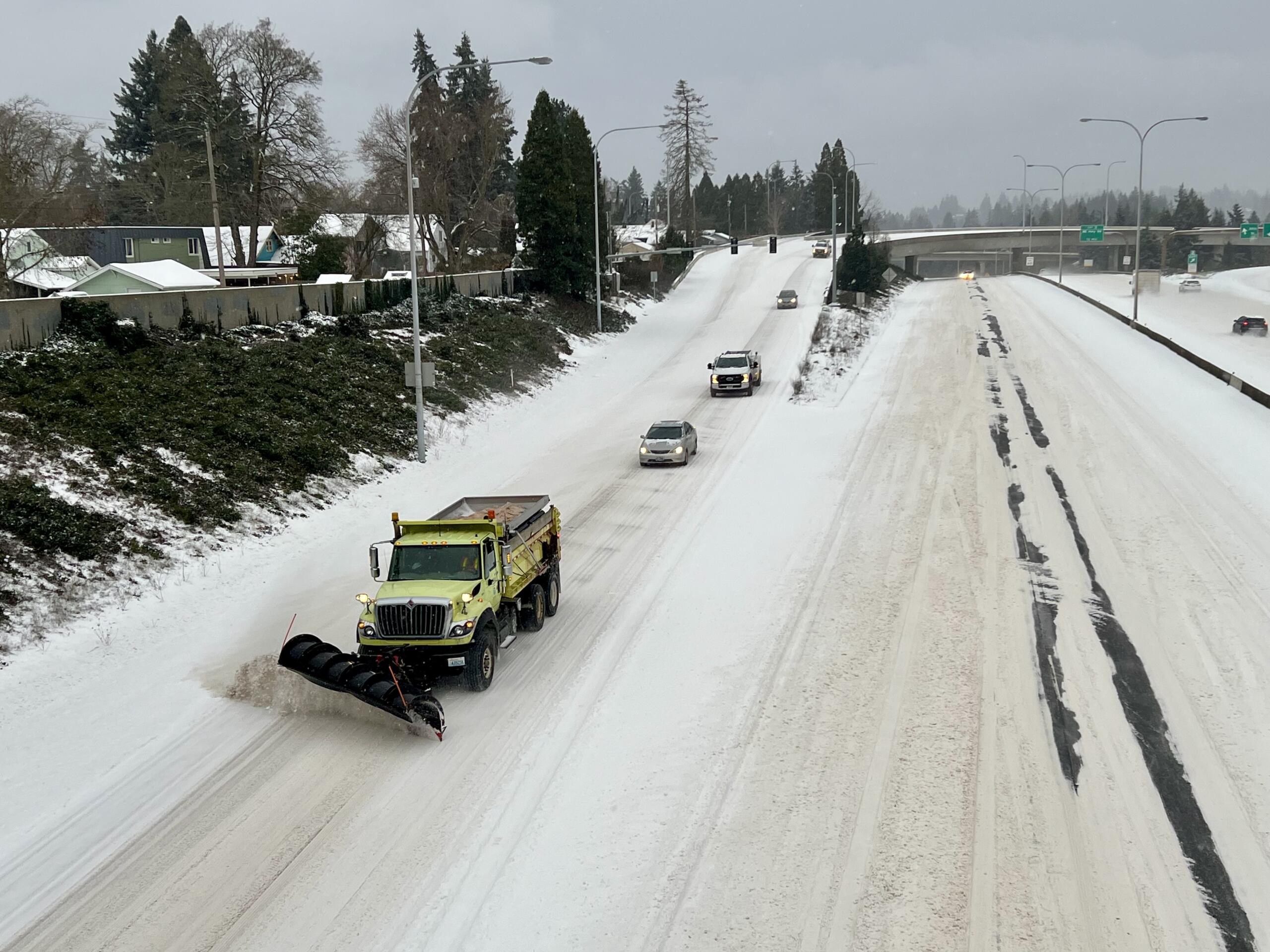 A snow plow clears state Highway 500 on Saturday in Vancouver.