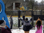 A gravel distribution yard operates without a permit across the street from Fairmount Elementary School as students play at recess, Tuesday, Jan. 16, 2024, in Everett, Washington.