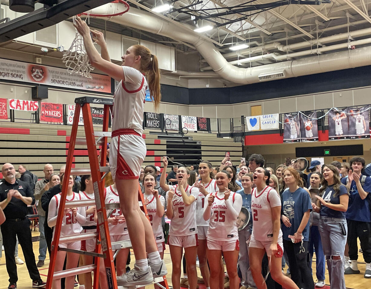 Camas girls basketball senior Addison Harris cuts down a piece of the net after the Papermakers clinched the 4A Greater St. Helens League title with a win over Union on senior night Friday, Feb. 2, 2024, at Camas High School.