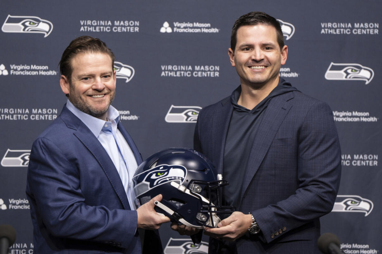 Seattle Seahawks NFL football team general manager John Schneider, left, and head coach Mike Macdonald pose for photos during an introductory press conference, Thursday, Feb. 1, 2024, in Renton, Wash.