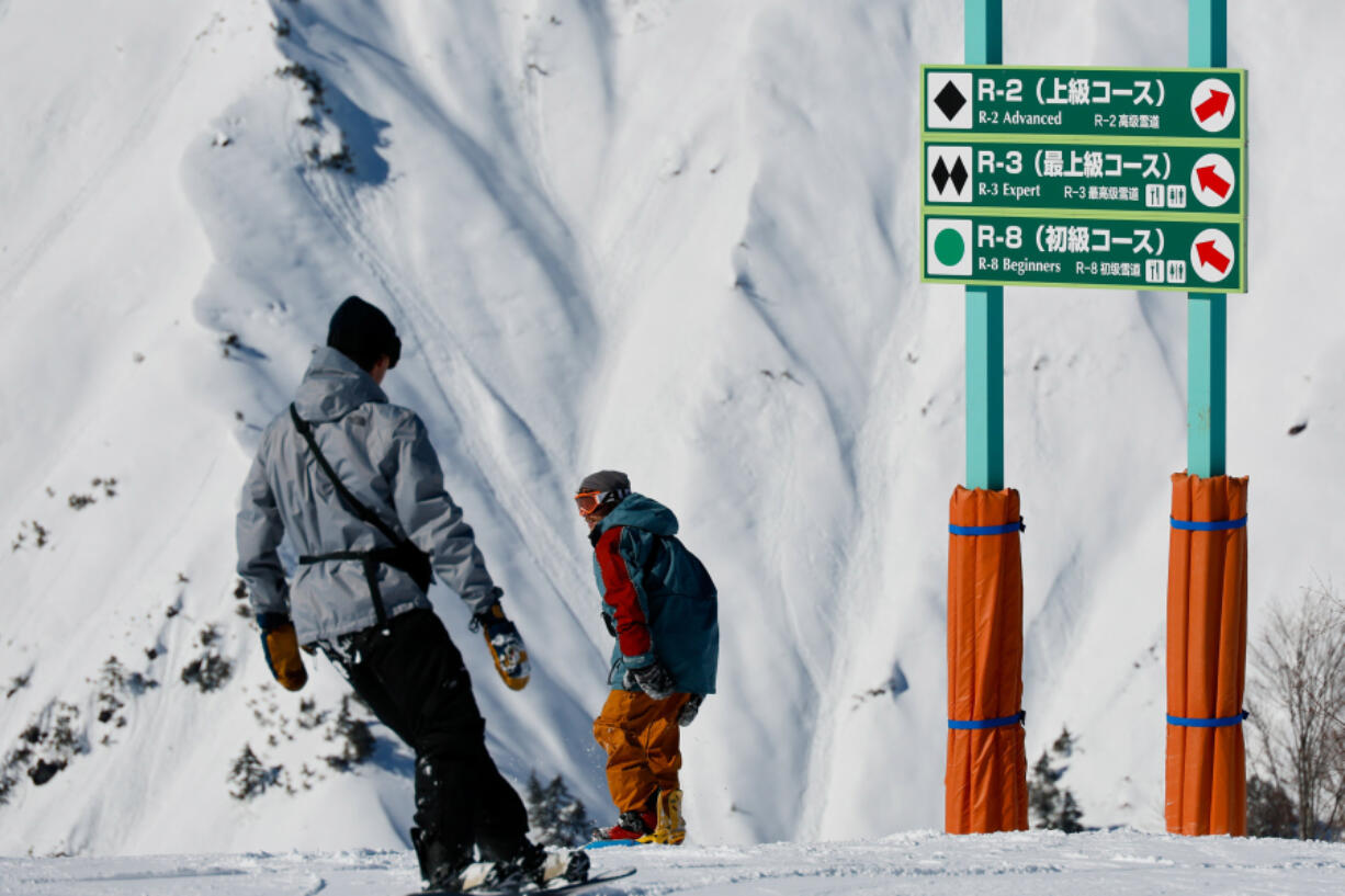 Two snowboarders head down the R-3 course as they cross into Hakuba 47 from Hakuba Goryu on Feb. 6, 2023, in Hakuba, Japan. Many of the resorts in the Hakuba Valley are connected and can be ridden on the same lift ticket.