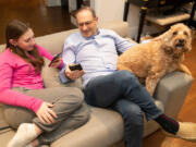 Will Fulmer, who owns an IT company, said he has had issues with cell service in and around his Bala Cynwyd, Pennsylvania, home for the past decade. He got so frustrated a year ago that he drove around and mapped the cell and data coverage in the region, showing dead spots. Will and his daughter, Shira, and dog, Max, are shown using their phones on Jan. 24, 2024.