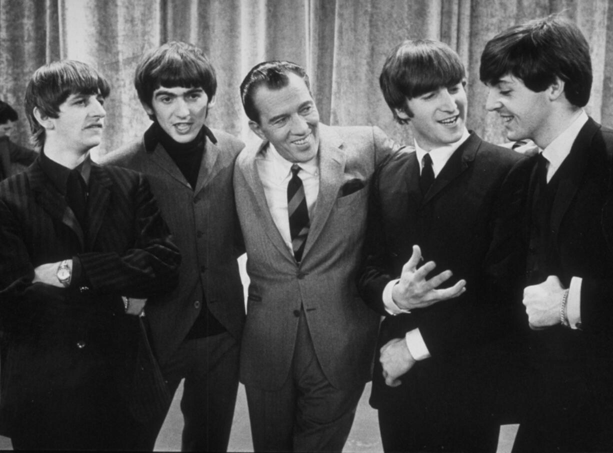 American television host Ed Sullivan, middle, smiles along with the members of British rock group the Beatles, on the set of his television variety series, &ldquo;The Ed Sullivan Show,&rdquo; at CBS&rsquo;s Studio 50 on Feb. 9, 1964, in New York. From left, Ringo Starr, George Harrison, Sullivan, John Lennon and Paul McCartney.