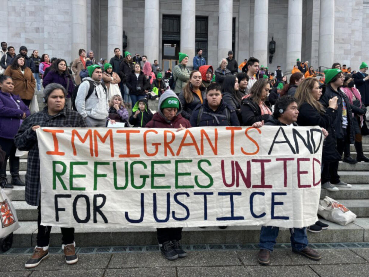 Immigrants, refugees and advocates rally at the Washington state Capitol, Feb. 7, 2024.