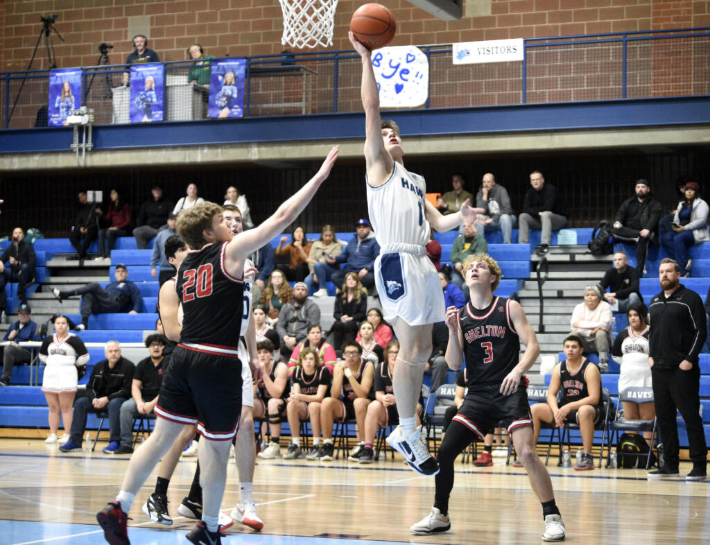 Hockinson’s Ryker Kitchen (1) goes up for a shot as Shelton defenders look on during the Class 2A boys basketball district pigtail game on Thursday, Feb. 8, 2024, at Hockinson High School.