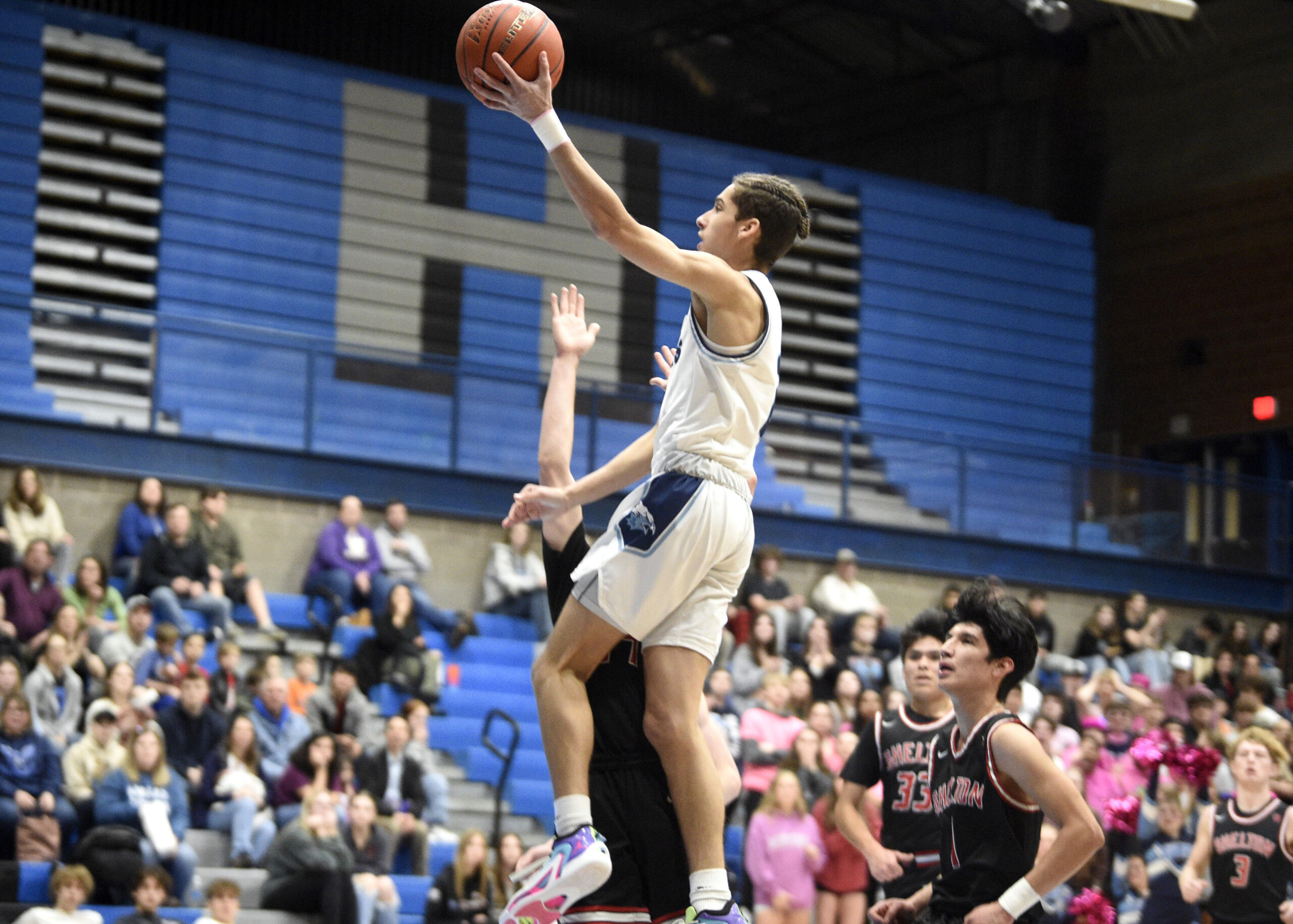 Hockinson’s Tanner Williams elevates for a layup as Shelton defenders look on during a Class 2A boys basketball district pigtail game on Thursday, Feb. 8, 2024, at Hockinson High School.