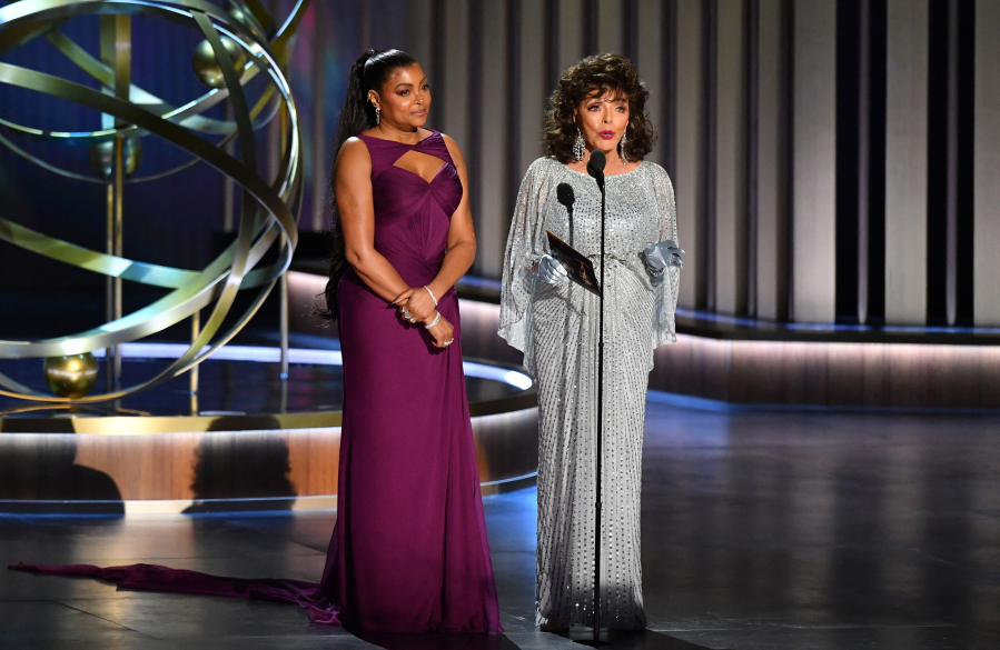 Actress Taraji P. Henson, left, and Dame Joan Collins speak Jan. 15 during the 75th Emmy Awards at the Peacock Theatre at L.A. Live in Los Angeles.