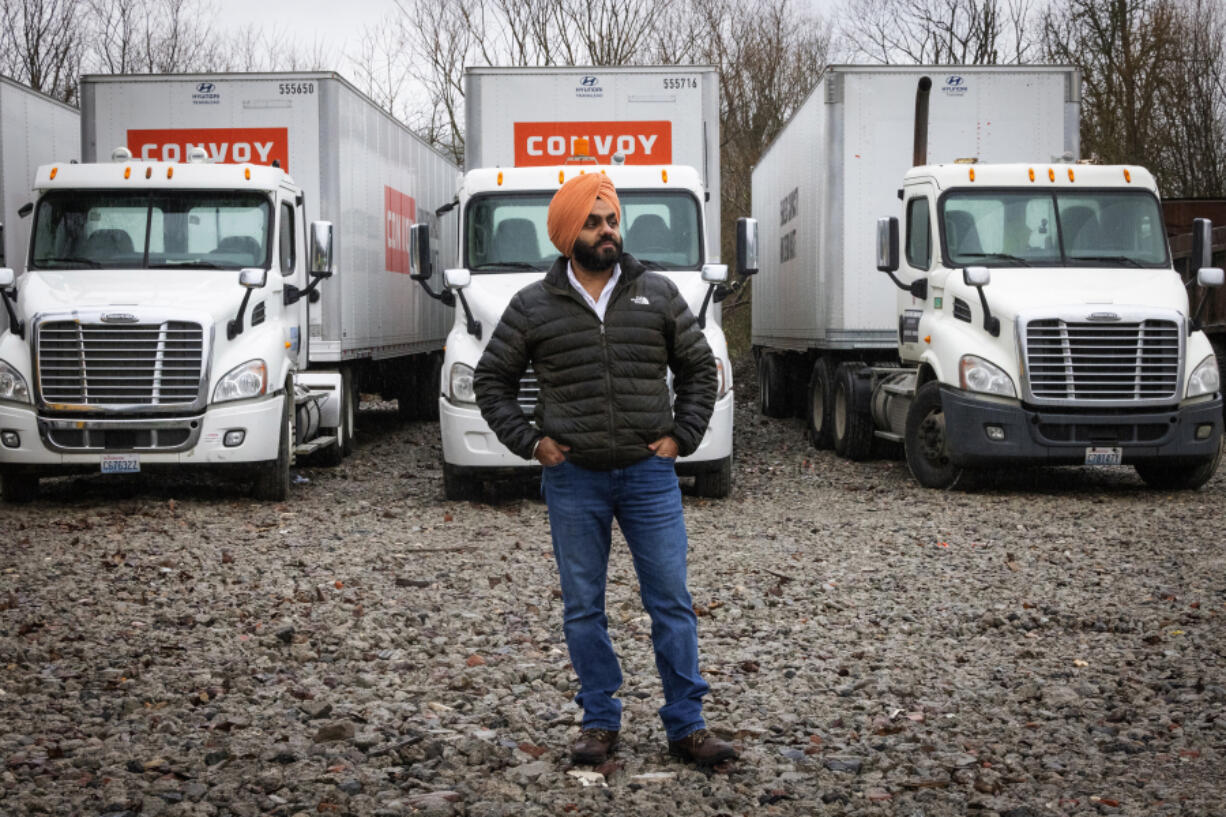 Angadjot (AJ) Singh Sandhu, Wednesday, Jan. 10, 2024, in Auburn with the trucks he owns (the cabs), before returning Convoy trailers (what is pulled). Sandhu is owed $40,000 and also has other losses after his small trucking business used Convoy.
