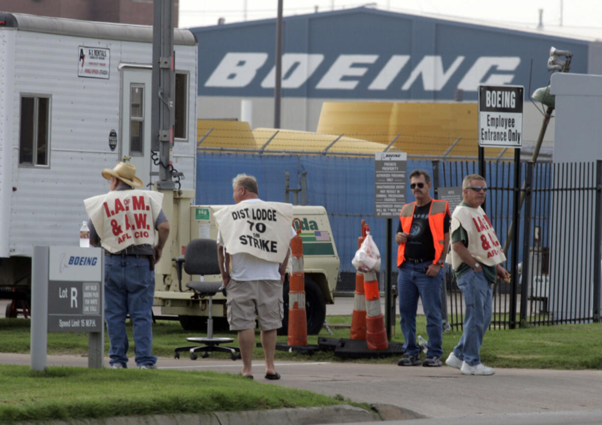 On Sept. 2, 2005, Machinists Union members from the Aero Lodge 834 walk in front of a gate at the Boeing Wichita Plant after voting to go on strike on  in Wichita, Kansas. (Larry W.