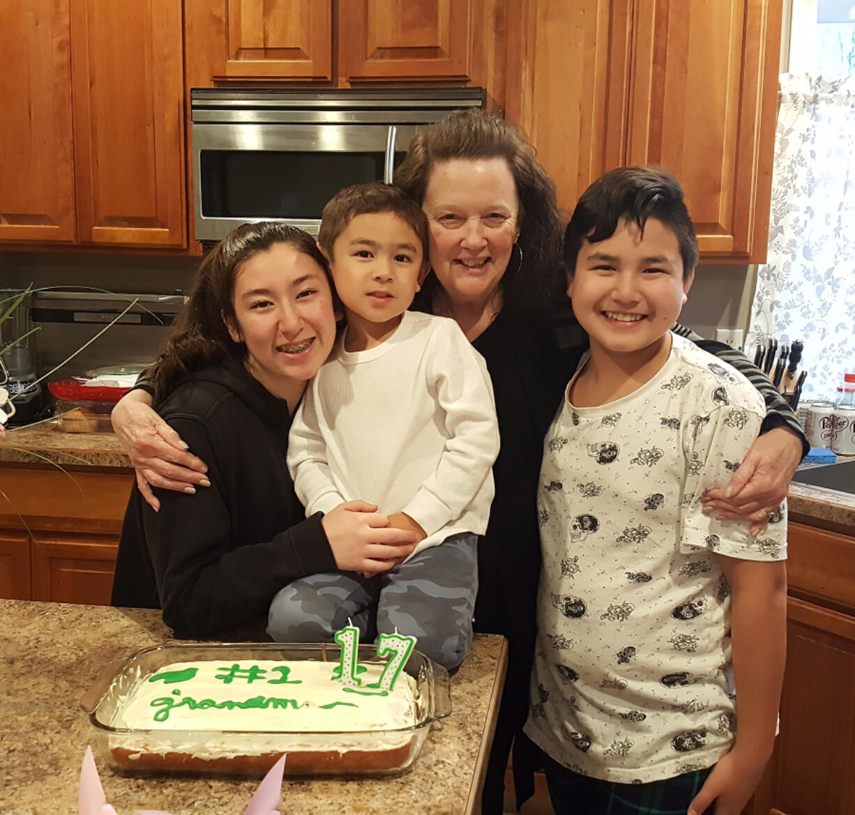 Sandra Ladd, (second from right), is pictured with her grandchildren (left to right): Emma Sasse, Hunter Sasse and Ben Sasse in an undated photo. Ladd, 71, was found murdered in her Washougal home in June 2020.