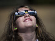 Abby Prudente of Vancouver, 11, looks up at the solar eclipse Aug. 21, 2017, from Fort Vancouver.