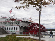 A pedestrian strolls past the American Empress as it is docked along the Columbia River at the Vancouver waterfront on May 1, 2023.