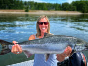 Mindi Eleazer, the wife of fishing guide Matt Eleazer, with a fine spring Chinook salmon she took from the Columbia River.