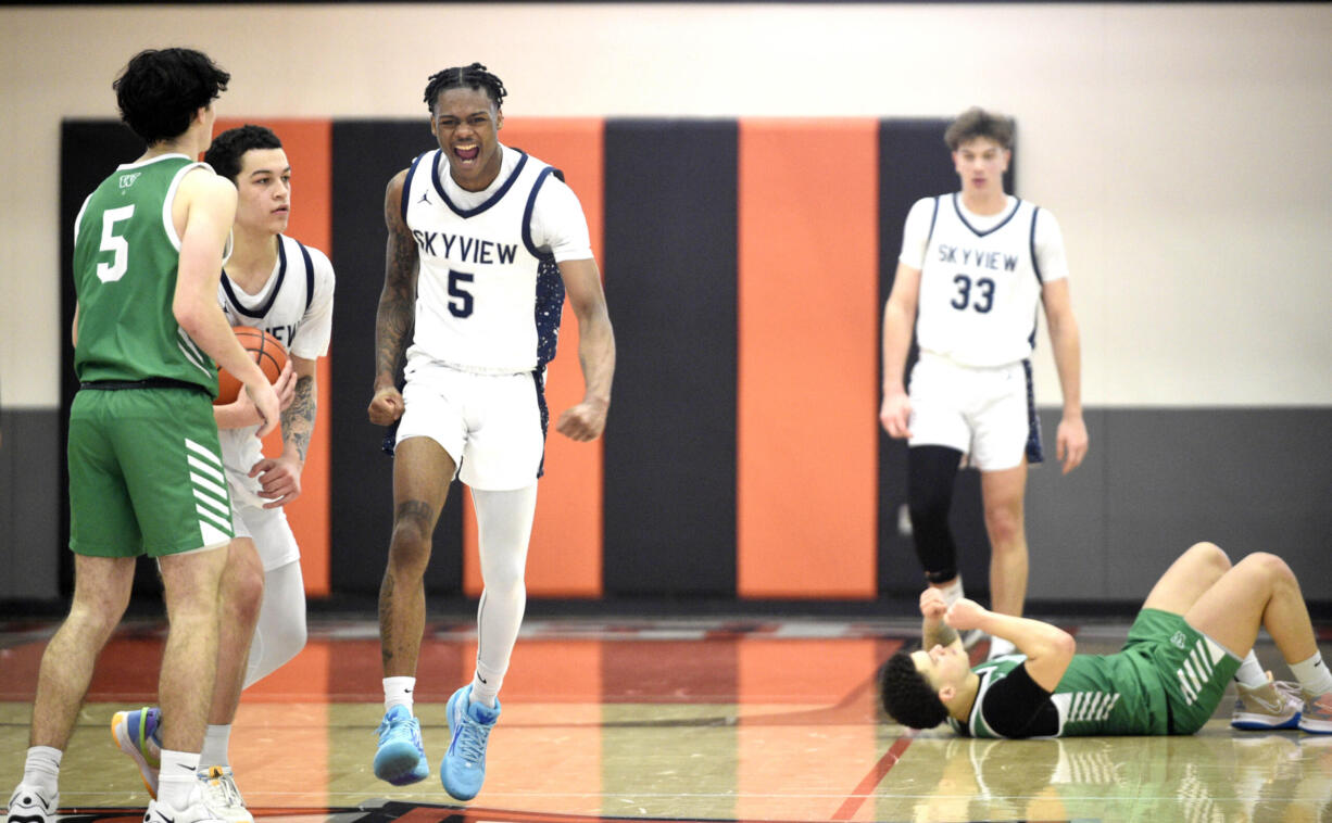 Skyview's Demaree Collins (5) after grabbing a steal and drawing a foul against Woodinville in the closing seconds of a Class 4A State Opening Round boys basketball game on Saturday, Feb. 24, 2024, at Battle Ground High School.