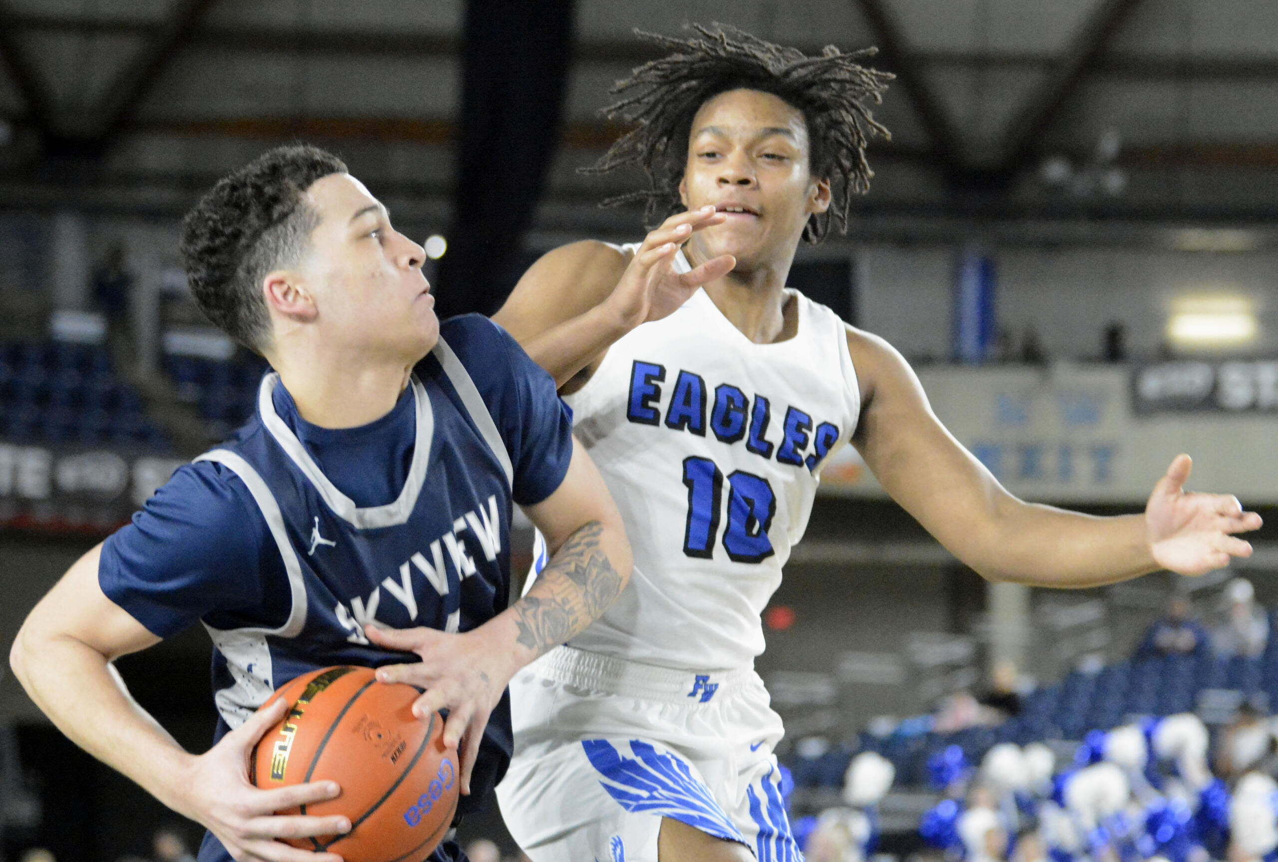 Skyview's Malakai Weimer, left, draws contact against Federal Way's Jacob Hurskin on a drive during a Class 4A Hardwood Classic Round-Of-12 game on Wednesday, Feb. 28, 2024, at the Tacoma Dome.