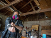 John Furniss, also known as The Blind Woodsman, rolls up his sleeves before getting to work at his studio in Washougal.