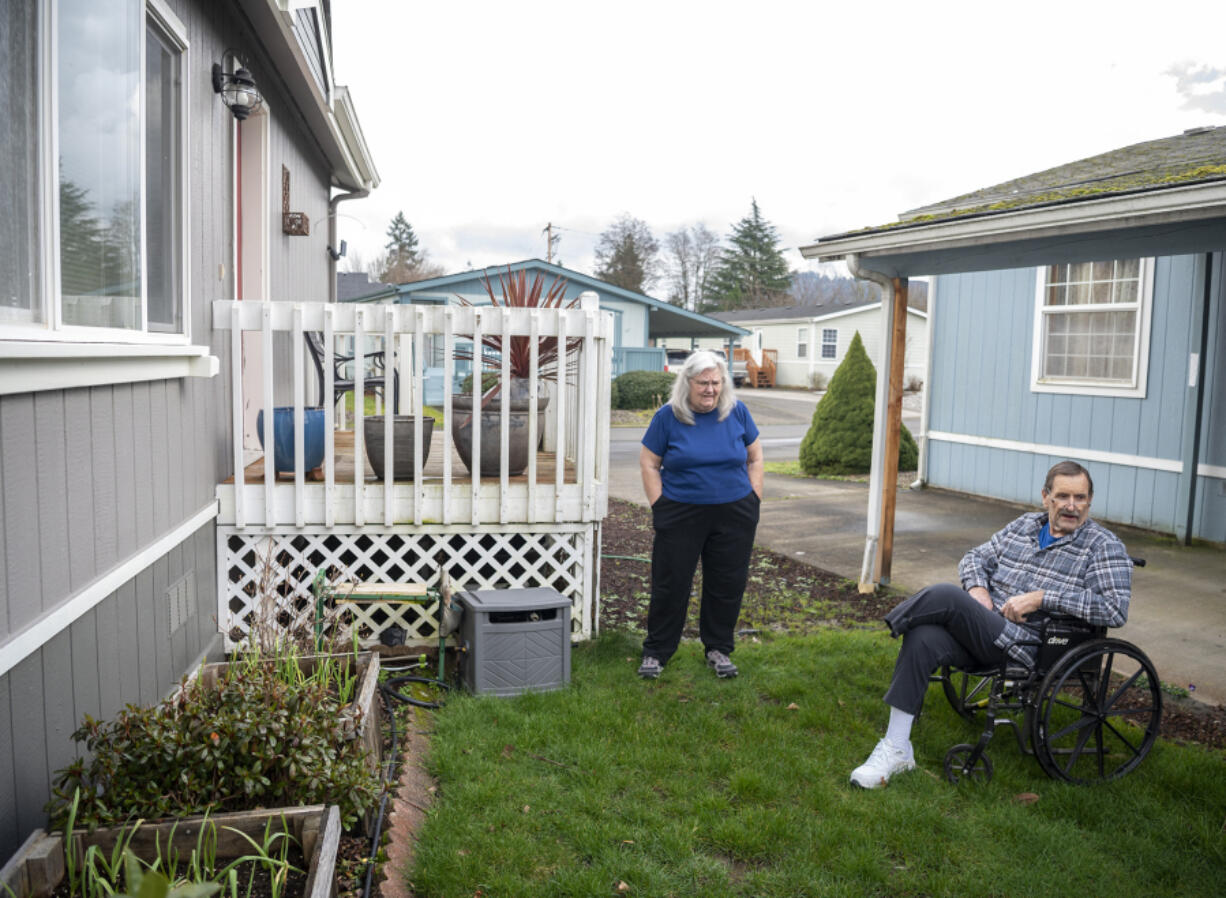 Phil Zorich, right, looks over his vegetable garden with his wife Robin on Tuesday. With rising rents, the Zoriches grow vegetables to offset their grocery bill.