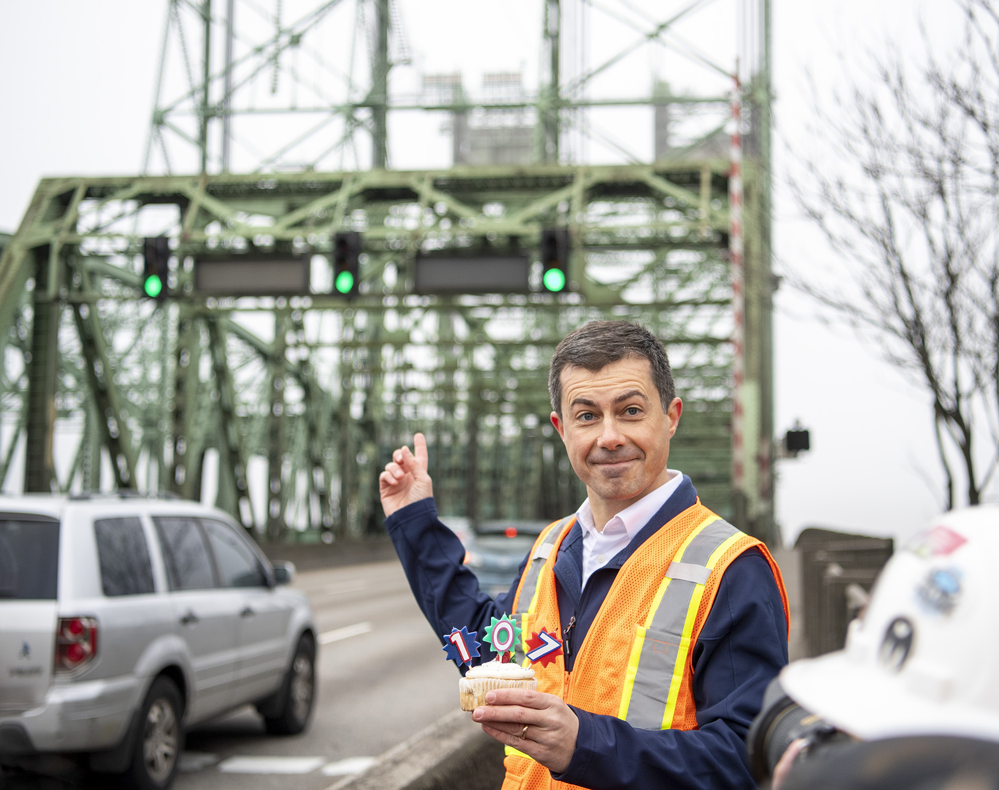 U.S. Department of Transportation Secretary Pete Buttigieg holds a cupcake celebrating the 107th birthday of the Interstate Five Bridge on Tuesday, Feb. 13, 2024, in Vancouver.
