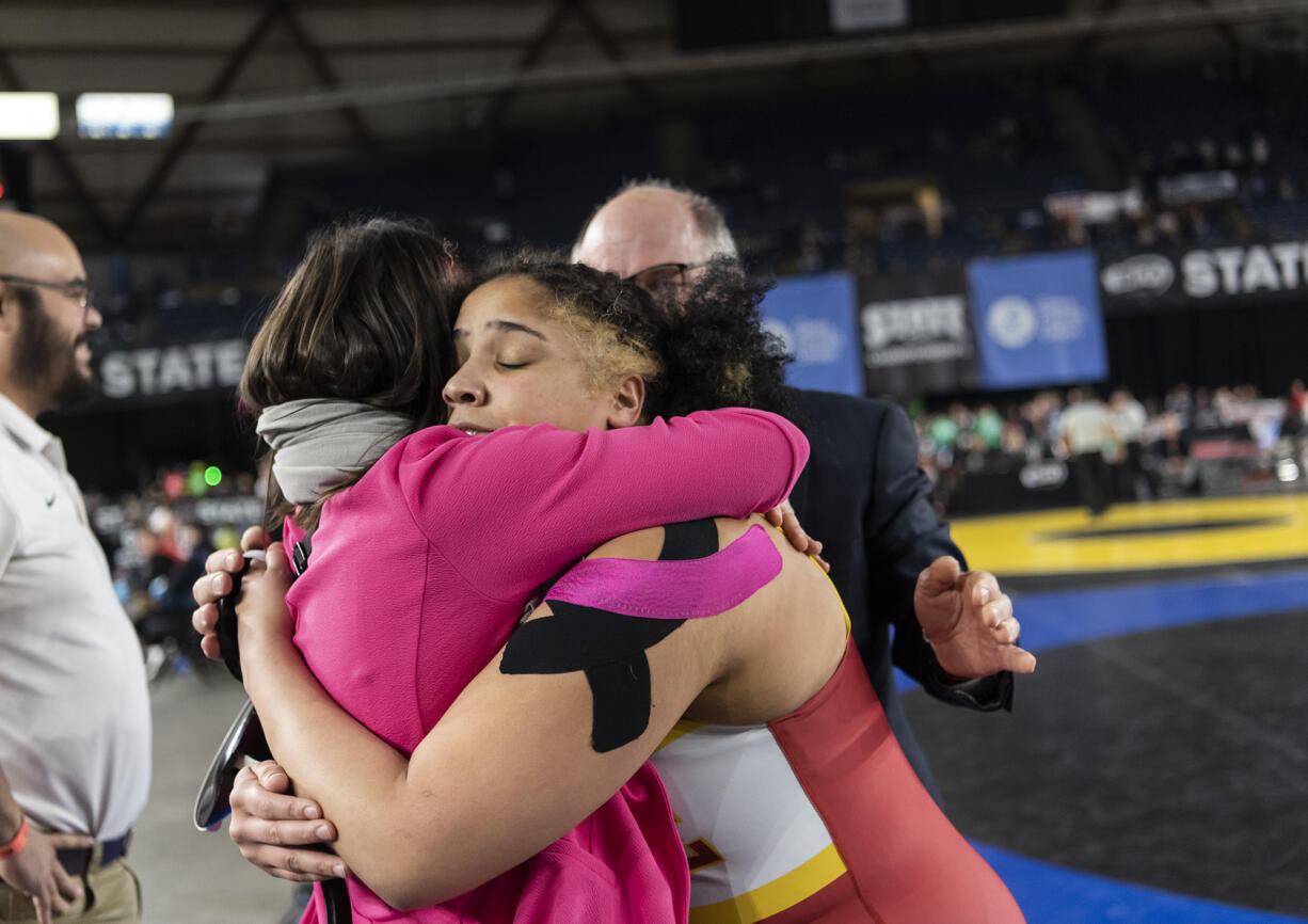 Prairie junior Faith Tarrant, center, celebrates after winning the 3A/4A 235-pound state championship Saturday, Feb. 17, 2024, during the Mat Classic state wrestling tournament at Tacoma Dome. Tarrant won by fall over Tahoma’s Katherine Petersen.