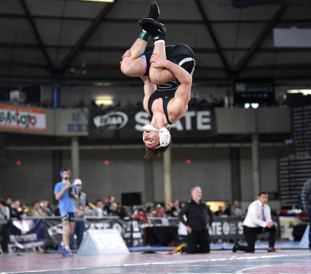 Skyview senior Owen Pritchard does a backflip after winning the 4A 126-pound championship Saturday, Feb. 17, 2024, during the Mat Classic state wrestling tournament at Tacoma Dome.