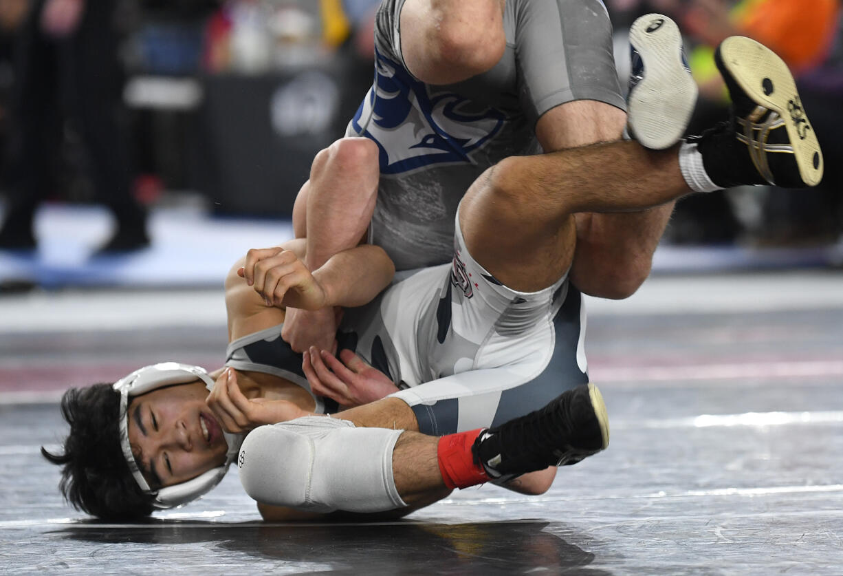 Union junior Noah Koyama, left, wrestles in the 4A 138-pound championship match Saturday, Feb. 17, 2024, during the Mat Classic state wrestling tournament at Tacoma Dome. Koyama won by decision, 4-2, over Chiawana’s Daeton Johnson.