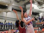 Ridgefield senior Morgan Goode, right, shoots the ball Friday, Feb. 23, 2024, during the Spudders’ 59-46 win against Kingston in a 2A Opening Round game at Battle Ground High School.