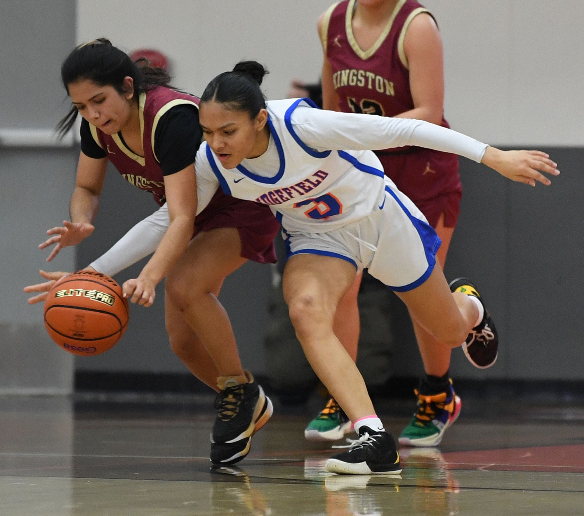 Ridgefield sophomore Savannah Chanda, right, swipes the ball from Kingston sophomore Tati Fontes-Lawrence on Friday, Feb. 23, 2024, during the Spudders’ 59-46 win against Kingston in a 2A Opening Round game at Battle Ground High School.