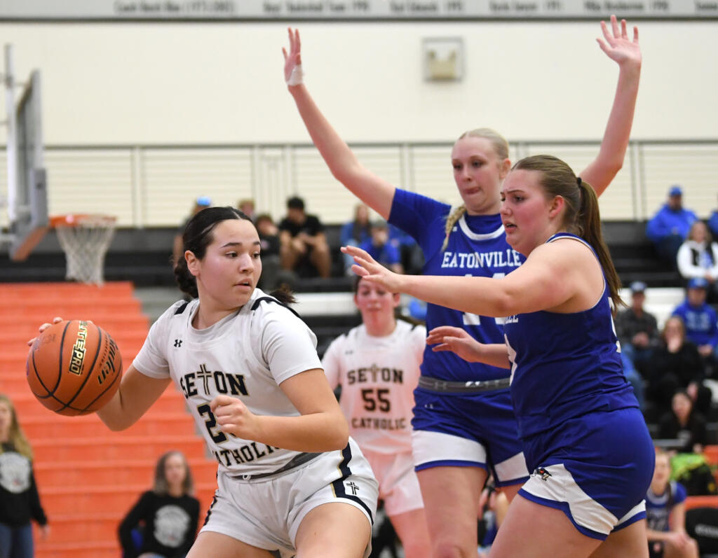 Seton Catholic sophomore Tiffany Sheldon, left, looks for an open teammate Friday, Feb. 23, 2024, during the Cougars’ 40-36 loss to Eatonville in the 1A Opening Round of the state playoffs at Battle Ground High School.