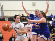 Seton Catholic sophomore Tiffany Sheldon, left, looks for an open teammate Friday, Feb. 23, 2024, during the Cougars’ 40-36 loss to Eatonville in the 1A Opening Round of the state playoffs at Battle Ground High School.