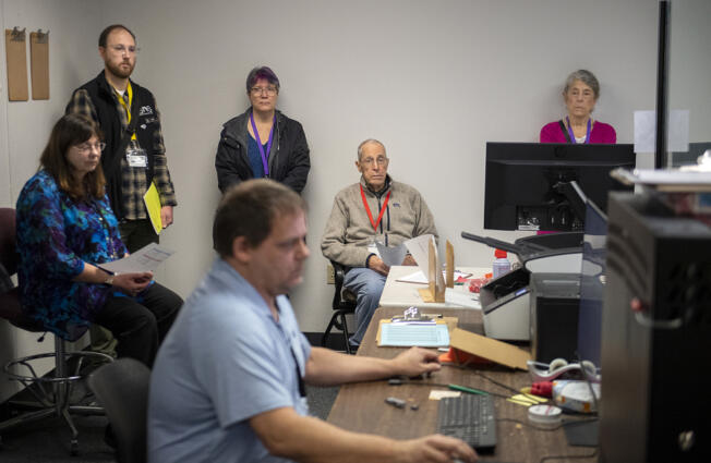 Observers look on as election coordinator Robert Easterly, foreground, conducts logic and accuracy tests before the March 12 presidential primary at the Clark County Elections Office. &ldquo;It&rsquo;s a proofing process that makes sure that everything&rsquo;s correct,&rdquo; Clark County Elections Director Cathie Garber said.