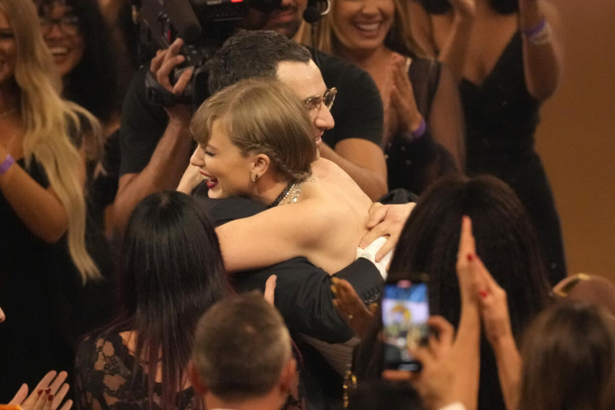 Jack Antonoff, left, and Taylor Swift embrace after winning album of the year for &ldquo;Midnights&rdquo; during the 66th annual Grammy Awards on Sunday, Feb. 4, 2024, in Los Angeles.