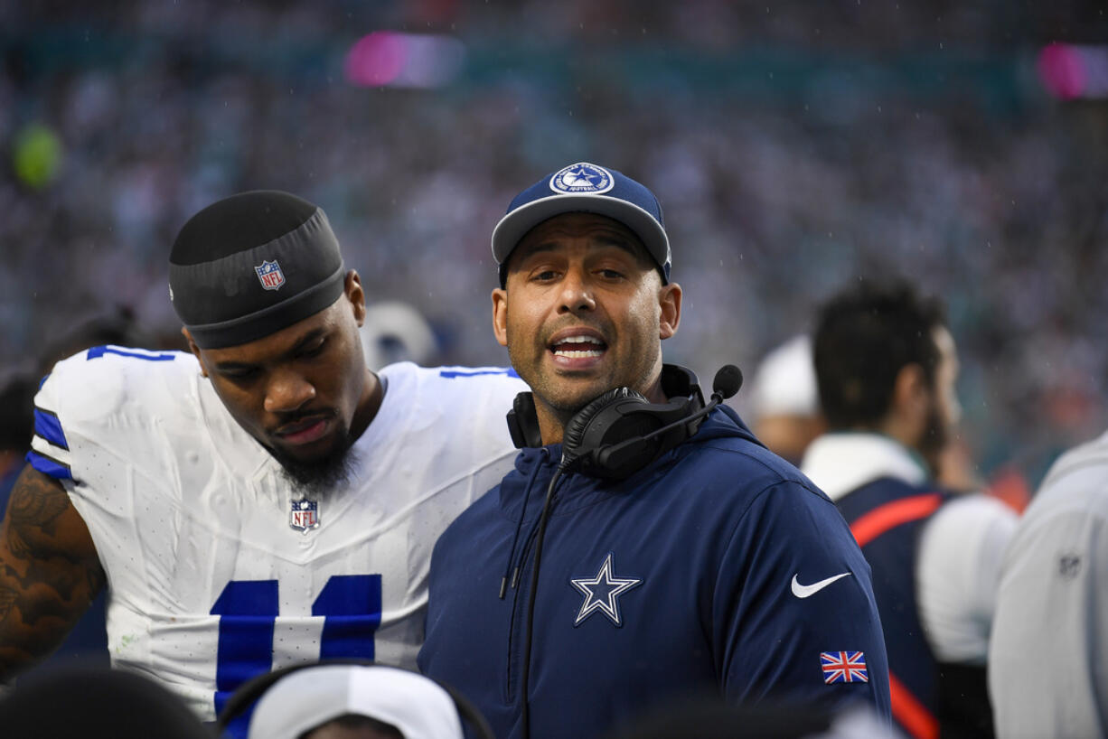 Dallas Cowboys coach Aden Durde talks to his players during the first half of an NFL football game against the Miami Dolphins, Sunday, Dec. 24, 2023, in Miami Gardens, Fla.
