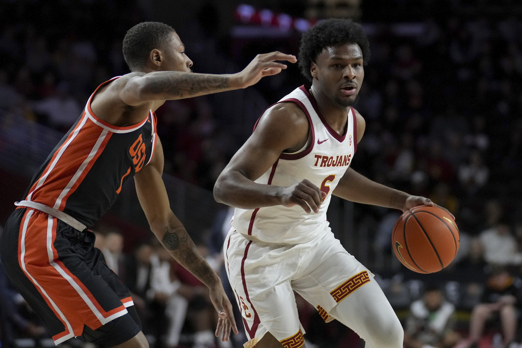 Southern California guard Bronny James (6) dribbles against Oregon State guard Christian Wright (1) during the first half of an NCAA college basketball game in Los Angeles, Saturday, Feb. 3, 2024.
