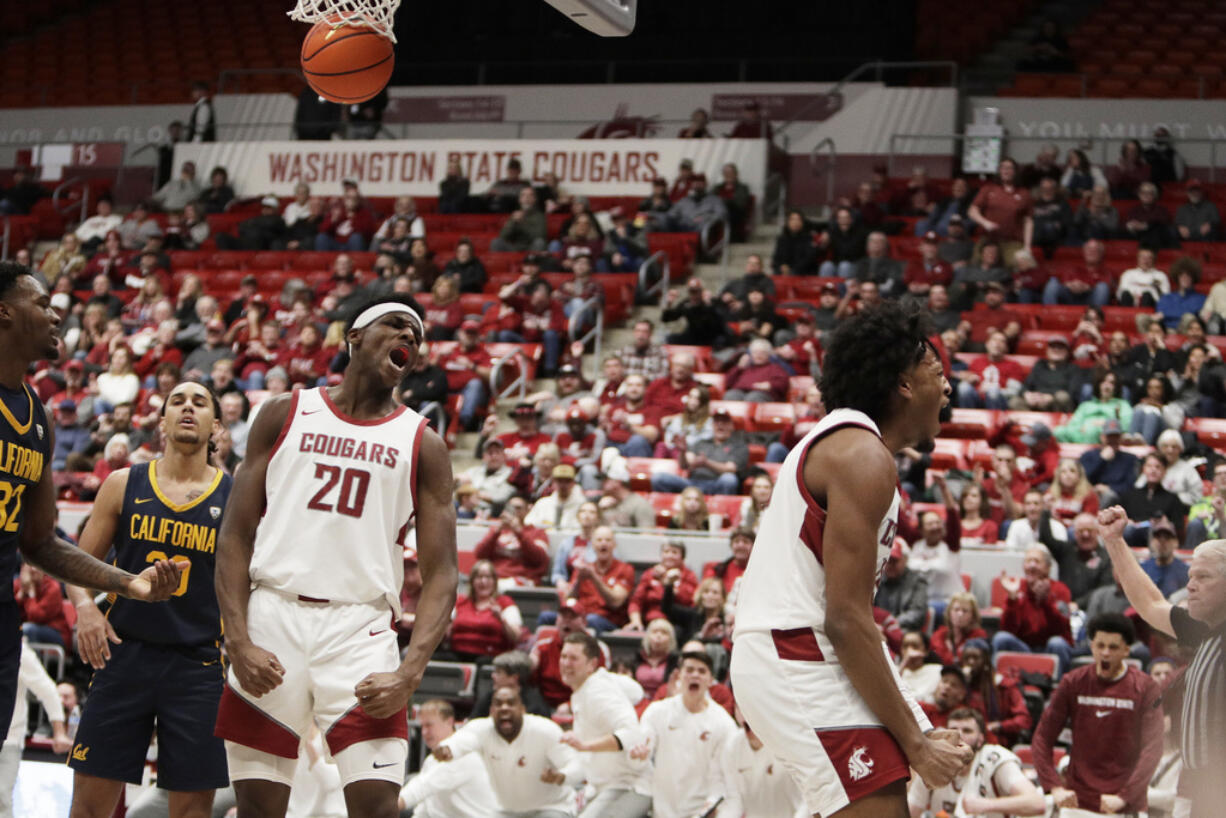 Washington State forward Isaac Jones, right, celebrates his basket next to teammate Rueben Chinyelu (20) during the second half of an NCAA college basketball game against California, Thursday, Feb. 15, 2024, in Pullman, Wash.